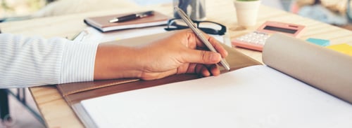 Preview: Banner Woman hands writing empty notebook planing meeting agenda wooden table. Panorama Close up wom