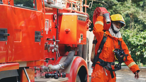 Preview: Fireman prepare equipment at fire engine truck. Man hand connect water tube with fire truck fighting