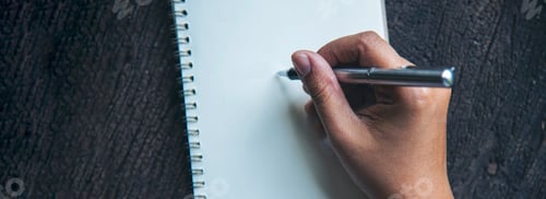 Preview: Banner Woman hands writing empty notebook planing meeting agenda wooden table. Panorama Close up wom