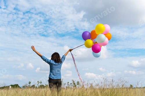 Preview: Woman holding balloons running on green meadow white cloud and blue sky with happiness Cheerful and