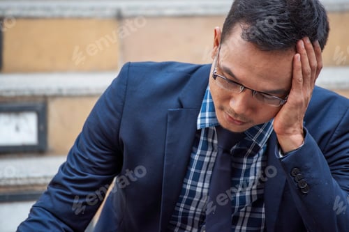 Preview: Recession Stress man using laptop work hard at home office headache, depressed from failure business