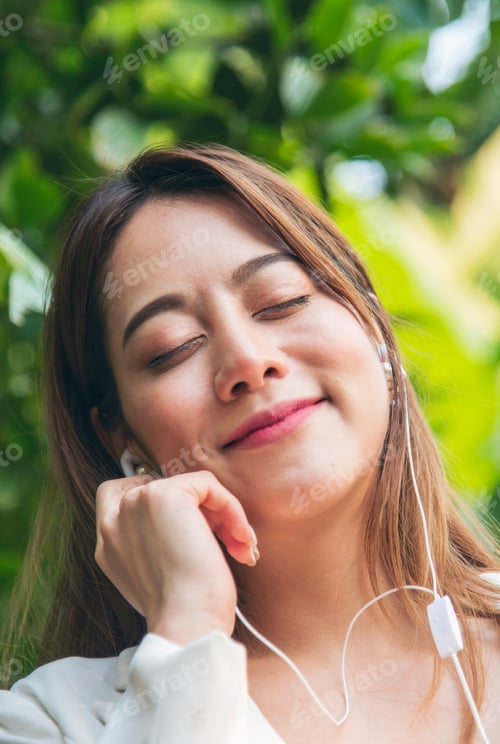 Preview: Vertical Horizon Happy asian woman use headphones listen to music from smartphone outdoor travel on