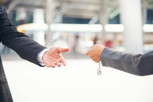Preview: Women Hand give remote control car key to man rental car service. Close up hands of young woman show