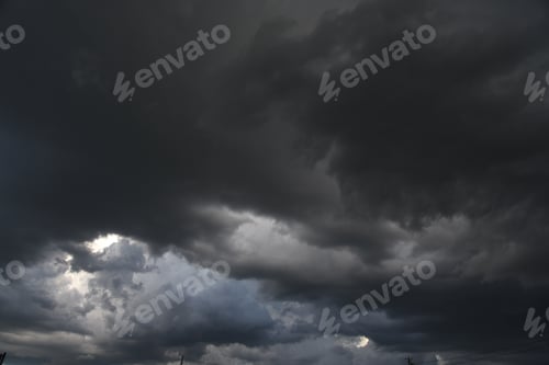 Preview: Dramatic dark storm thundercloud rain clouds on black sky background. Dark thunderstorm clouds rainn