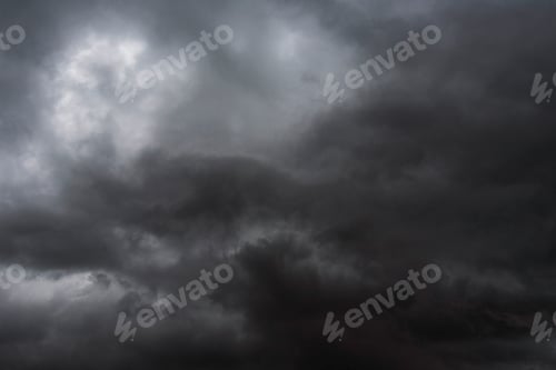 Preview: Dramatic dark storm rain clouds black sky background. Dark thunderstorm clouds rainny atmosphere. Me