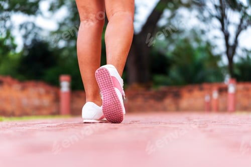 Preview: Sport sneakers footwear young woman knelt down do up shoelaces. Ready running shoes in sport exercis