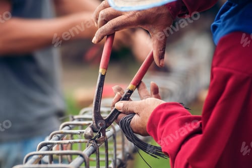 Preview: Construction Worker hands using pincer pliers iron wire. Outdoor Worker using wire bending pliers, c