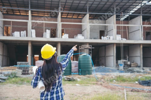Preview: Woman construction engineer hold blueprint wear plaid shirt safety white hard hat at construction si