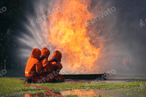 Preview: Firefighter Rescue team training in fire fighting extinguisher. Firefighter teamwork fighting with f
