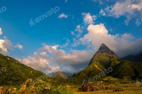 Preview: Beautiful landscape mountain green field grass meadow white cloud blue sky on sunny day. Majestic gr