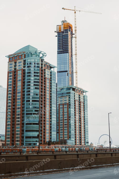 Preview: Construction of a tall building in an urban area with other structures nearby