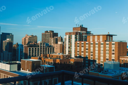 Preview: City skyline shows tall buildings and a clear blue sky during the early morning light in an urban