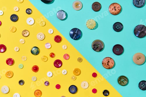 Preview: Assorted sewing buttons on yellow and blue background