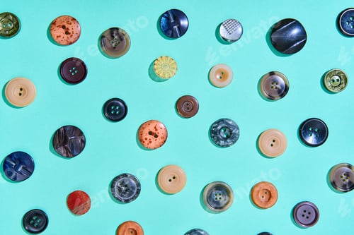 Preview: Colorful sewing buttons on bright blue background