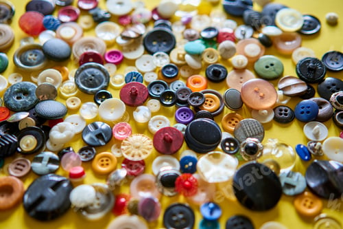 Preview: Colorful sewing buttons on bright yellow background