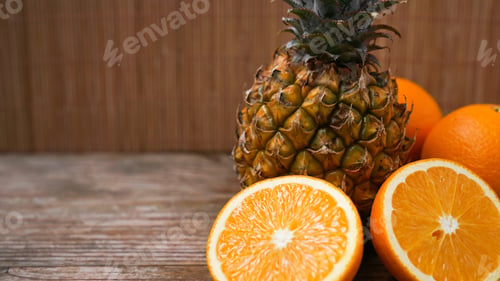 Preview: Pineapple and oranges. Tropical fruit on wooden table background