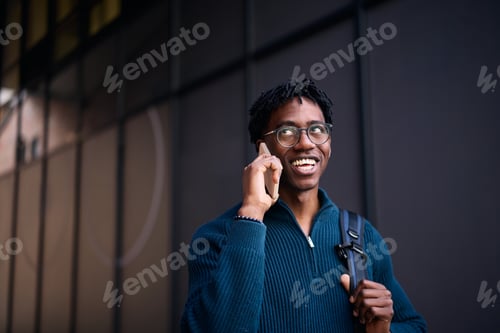 Preview: Happy African American man on the phone in the city.