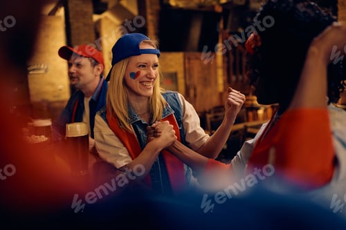 Preview: Happy woman and her friends celebrating their team's victory during world championship.