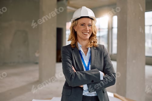 Preview: Happy female real estate developer at construction site looking at camera.