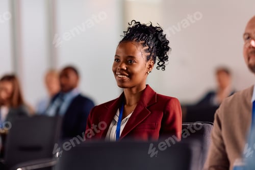 Preview: Happy black businesswoman attending an education event in convention center.