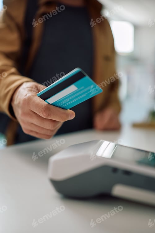 Preview: Close up of man paying contactless in a drugstore.