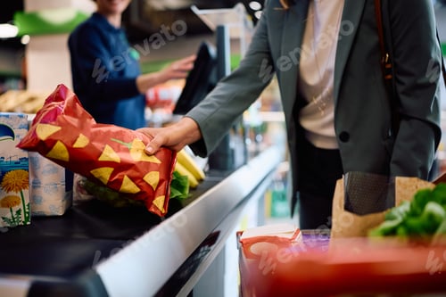 Preview: Close up of woman shopping in a supermarket.