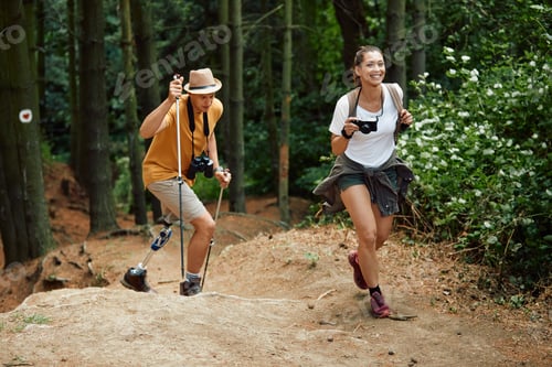 Preview: Happy hiker and her friends with leg disability walking through the woods.