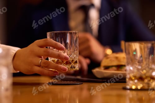 Preview: Close up of waitress serving drinking during a lunch in restaurant.