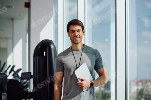 Preview: Portrait of happy fitness instructor in a gym looking at camera.