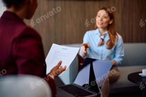 Preview: Close up of talent acquisition manager reading a job candidate's CV in the office.