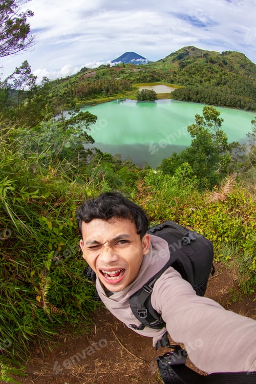 Preview: Hiker Selfie at Telaga Warna Dieng with Mountain Landscape Central Java