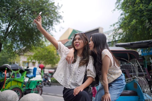 Preview: Playful Gen Z Friends Taking Selfie in Malioboro Yogyakarta