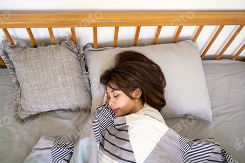 Preview: Young Asian Woman Sleeping Peacefully in Comfortable Bed at Home