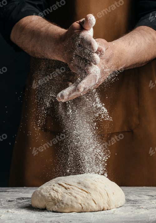 Preview: Baker clapping hands with flour dust over dough, bread making action close up