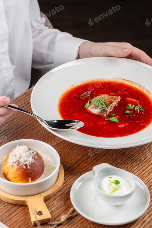 Preview: Traditional Ukrainian borscht served with sour cream and cheese bun
