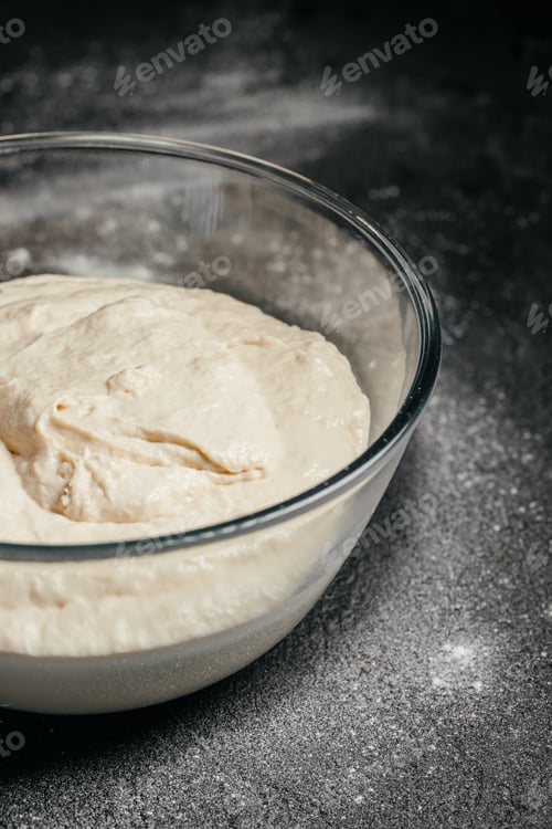 Preview: Proofed bread dough in glass bowl on dark background