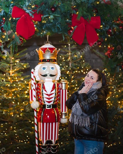 Preview: Delighted Woman Beside Nutcracker at Christmas Display