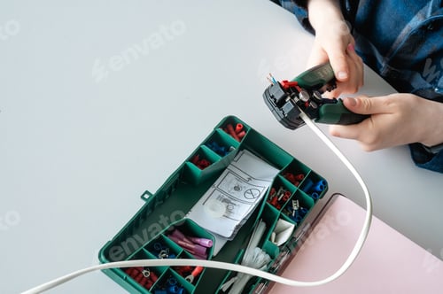 Preview: Overhead View of Hands Assembling Electronics Kit for STEM Project