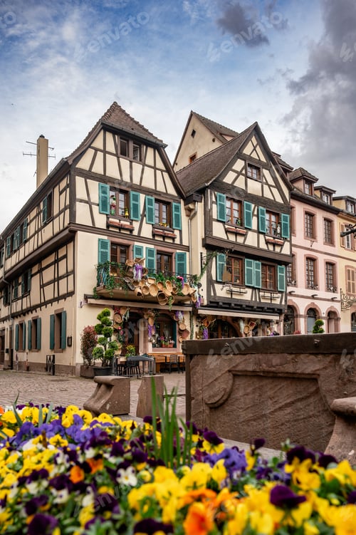 Preview: Colorful timbered houses around fountain with vibrant flower beds and