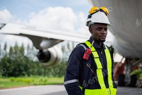 Preview: Professional aircraft maintenance engineer using safety equipment and tools to inspect an airplane e
