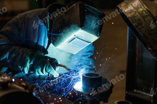 Preview: Industrial welder performing arc welding on metal component