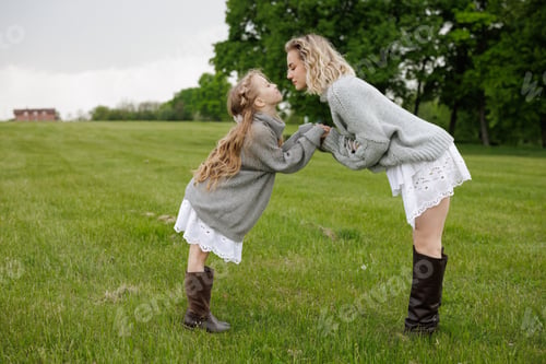 Preview: Mother and Daughter Sharing a Joyful Moment in a Green Field