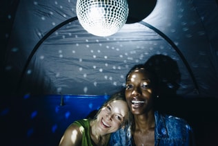 Friends partying in a tent