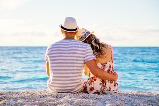 Young couple in love sitting on the beach