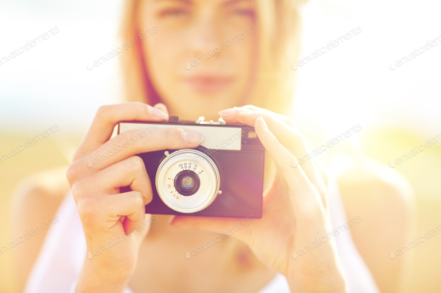 Cover for close up of woman photographing with film camera