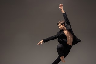 Man in casual office style clothes jumping isolated on studio background