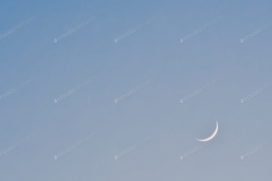 Cover for Moon in blue sky. Last light of the moon in a blue sky