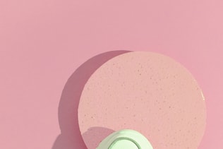 Minimal still life art. Fashion sport shoes concept. Pink colours trends. Stylish white sneakers