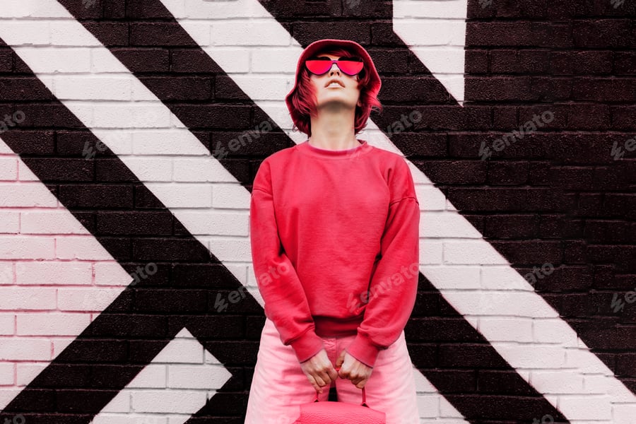 Cover for Hipster fashio woman in trendy viva magenta color sweatshirt and sunglasses. Color of 2023 year.