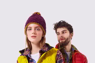 Young couple in casual clothes posing on white background